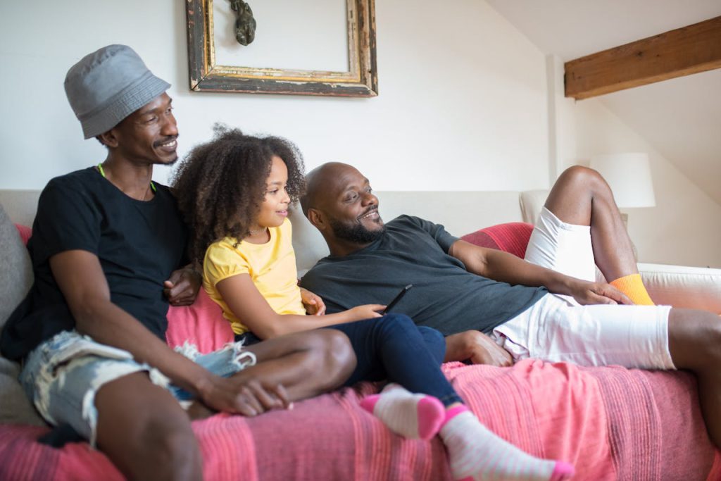 A joyful family relaxing together on a couch enjoying quality time.